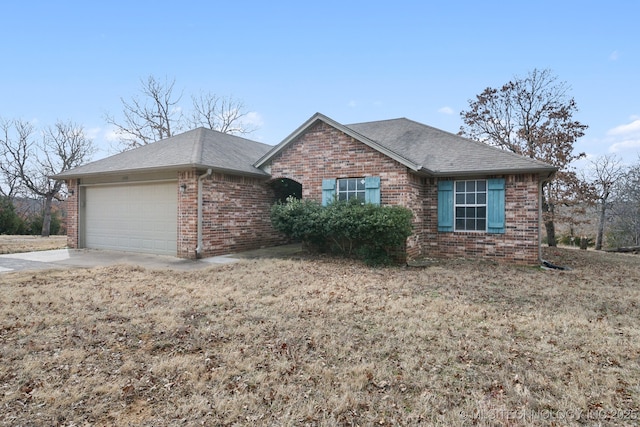 single story home featuring a garage, brick siding, roof with shingles, and concrete driveway