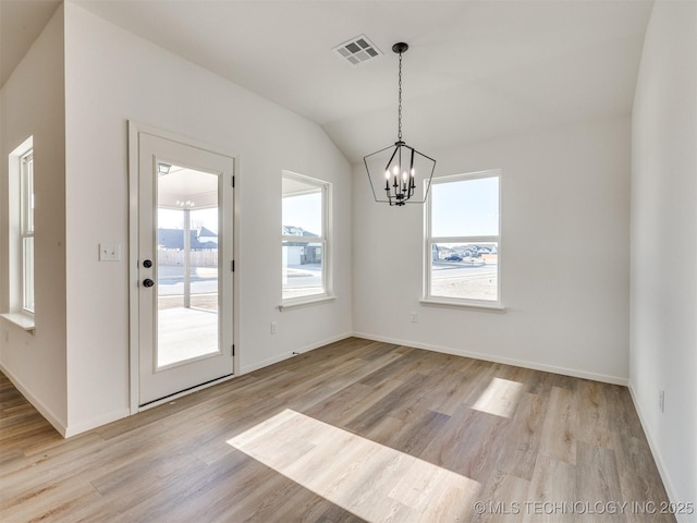 unfurnished dining area featuring a notable chandelier, plenty of natural light, light wood-style floors, and visible vents