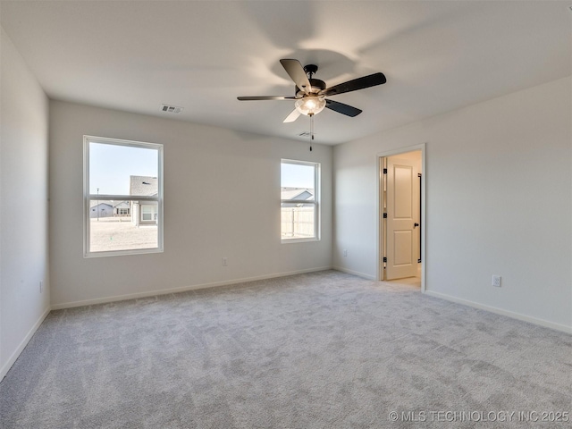 unfurnished room with visible vents, baseboards, ceiling fan, and carpet floors