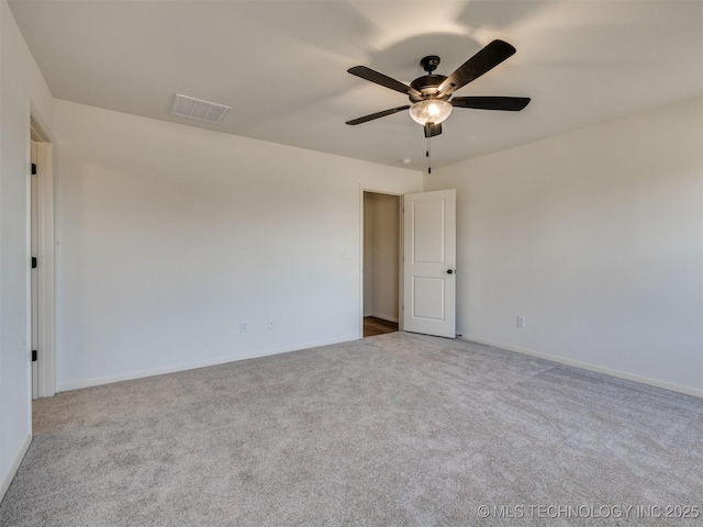 spare room with visible vents, baseboards, carpet, and ceiling fan