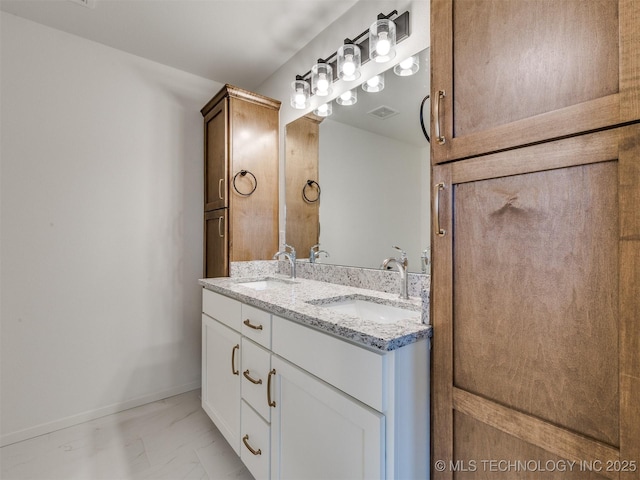 bathroom with double vanity, visible vents, marble finish floor, and a sink