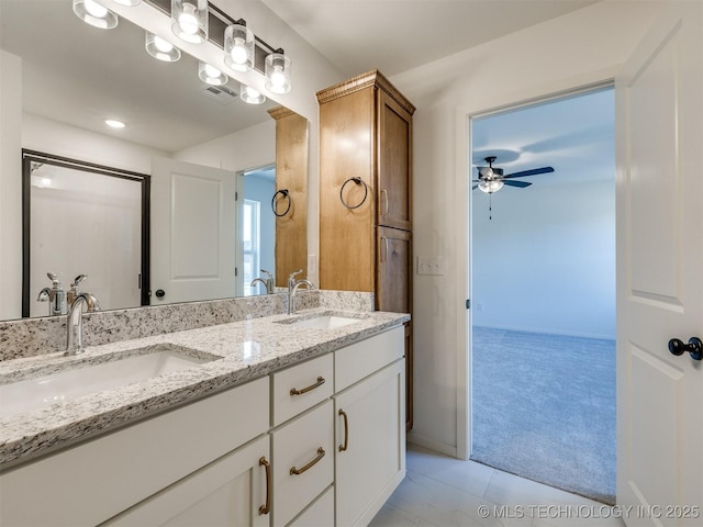 bathroom with ceiling fan, double vanity, visible vents, and a sink