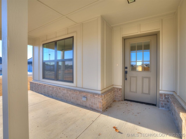 doorway to property with brick siding