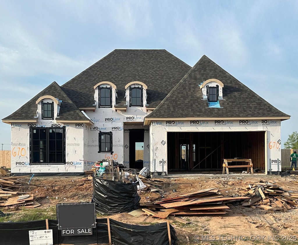 670 E 149th St S, Glenpool, OK 74033 - view of front facade featuring a shingled roof and an attached garage