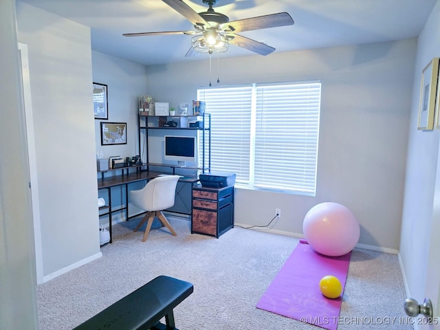 home office with a ceiling fan, baseboards, and carpet floors