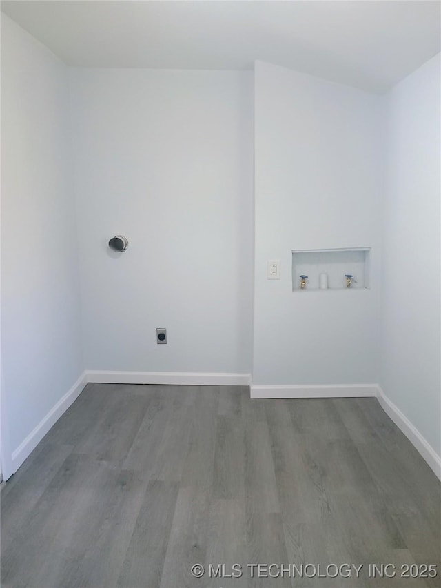 clothes washing area featuring hookup for a washing machine, wood finished floors, baseboards, and electric dryer hookup