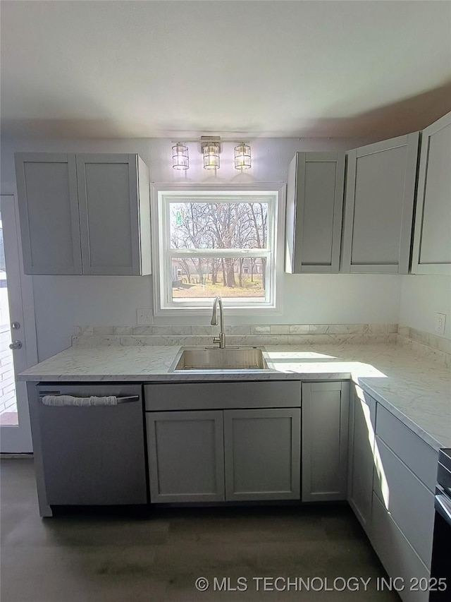 kitchen with a sink, stainless steel dishwasher, and gray cabinets