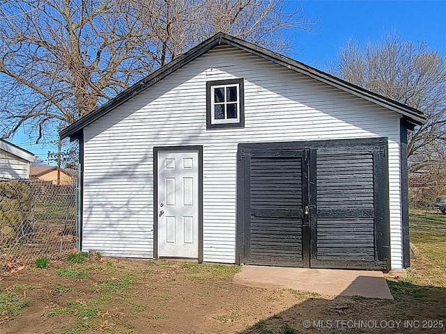 view of outdoor structure with an outbuilding and fence