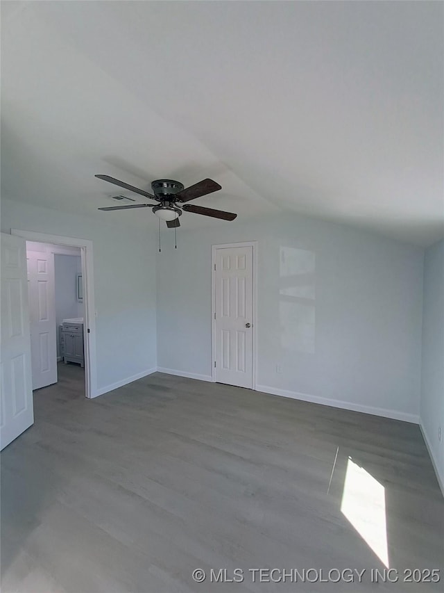 empty room with a ceiling fan, wood finished floors, and baseboards