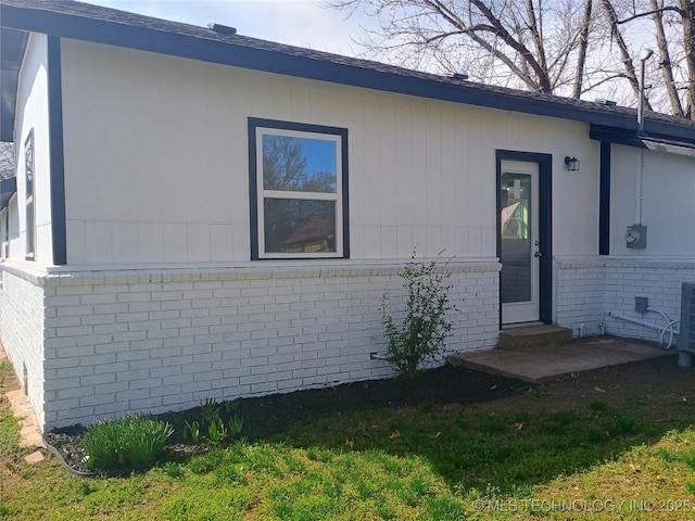 property entrance featuring brick siding