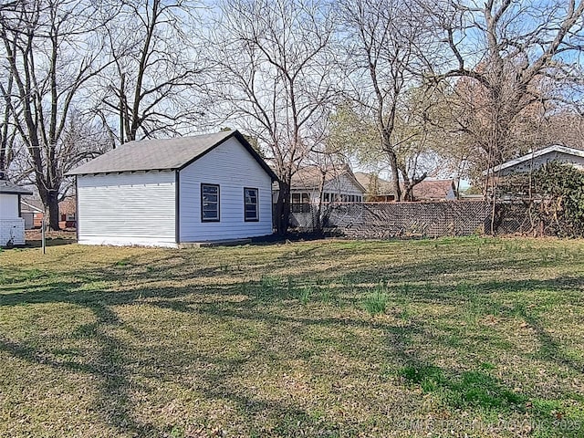 view of yard with an outdoor structure and fence