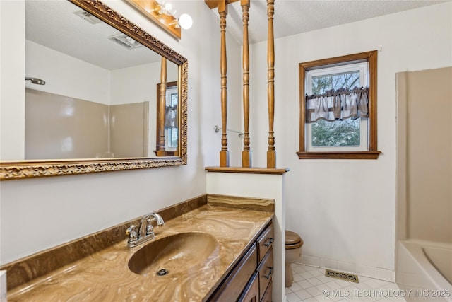 bathroom with tile patterned floors, visible vents, toilet, a textured ceiling, and vanity