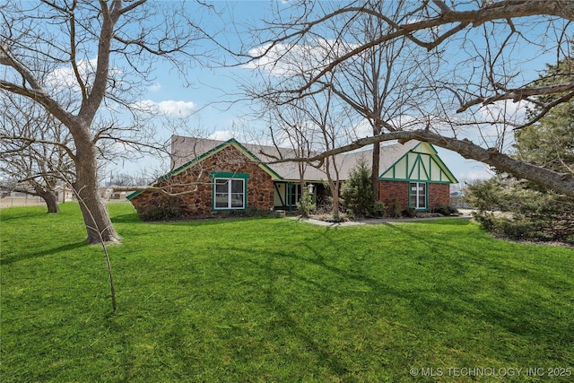 view of front facade featuring brick siding and a front lawn