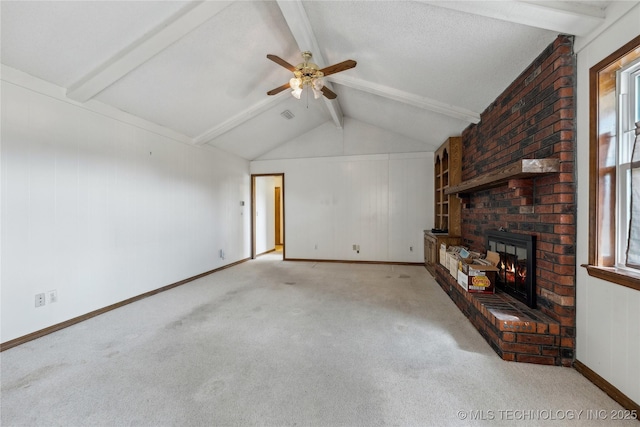 unfurnished living room with a brick fireplace, vaulted ceiling with beams, baseboards, carpet, and ceiling fan