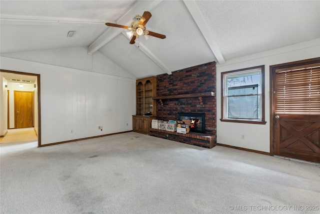 unfurnished living room featuring a brick fireplace, ceiling fan, carpet, lofted ceiling with beams, and a textured ceiling