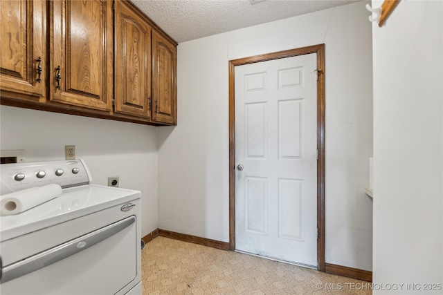 clothes washing area featuring light floors, baseboards, washer / dryer, cabinet space, and a textured ceiling