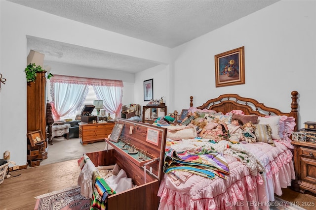20480 Burneyville, Burneyville, OK 73430 - bedroom with a textured ceiling and wood finished floors