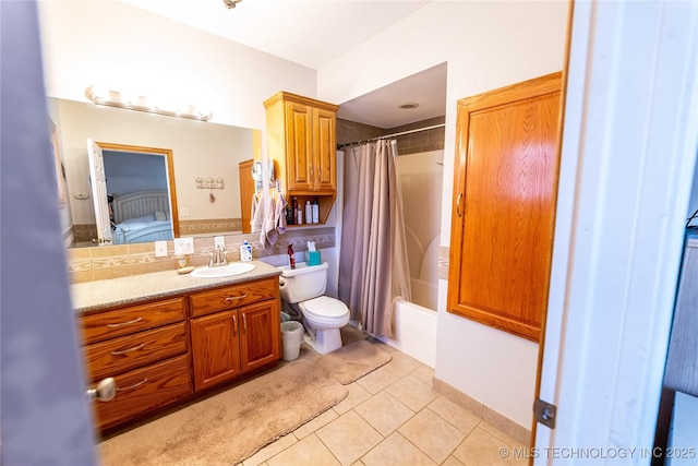 ensuite bathroom featuring shower / bathtub combination with curtain, toilet, ensuite bath, tile patterned flooring, and vanity