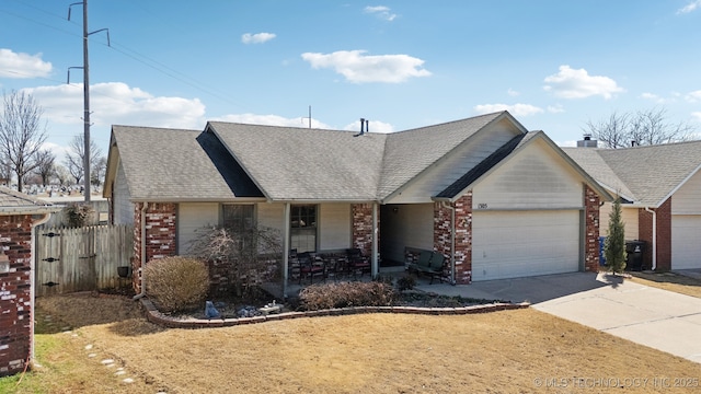 single story home featuring a garage, brick siding, driveway, and a shingled roof