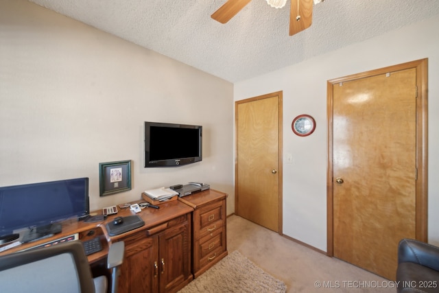 office with light carpet, a textured ceiling, and a ceiling fan