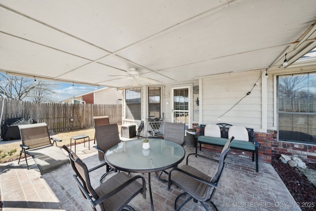 view of patio / terrace featuring outdoor dining area and fence