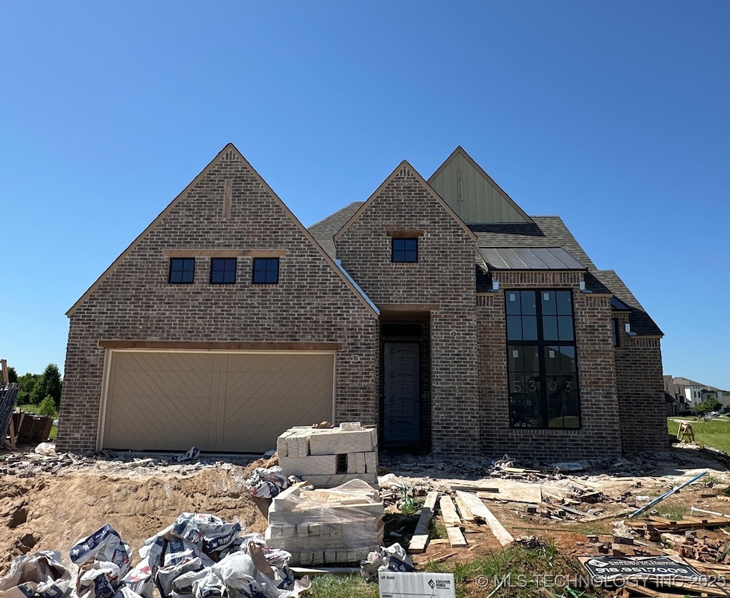 5303 E 126th St S, Bixby, OK 74008 - view of front of home with brick siding, a garage, and board and batten siding