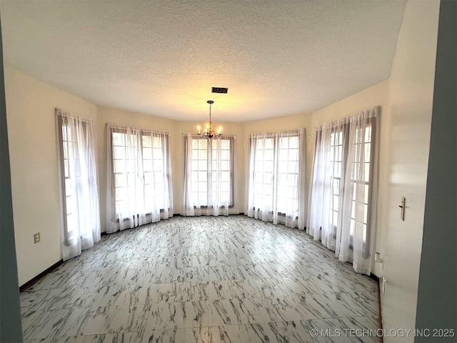 unfurnished dining area featuring visible vents, a notable chandelier, and a textured ceiling