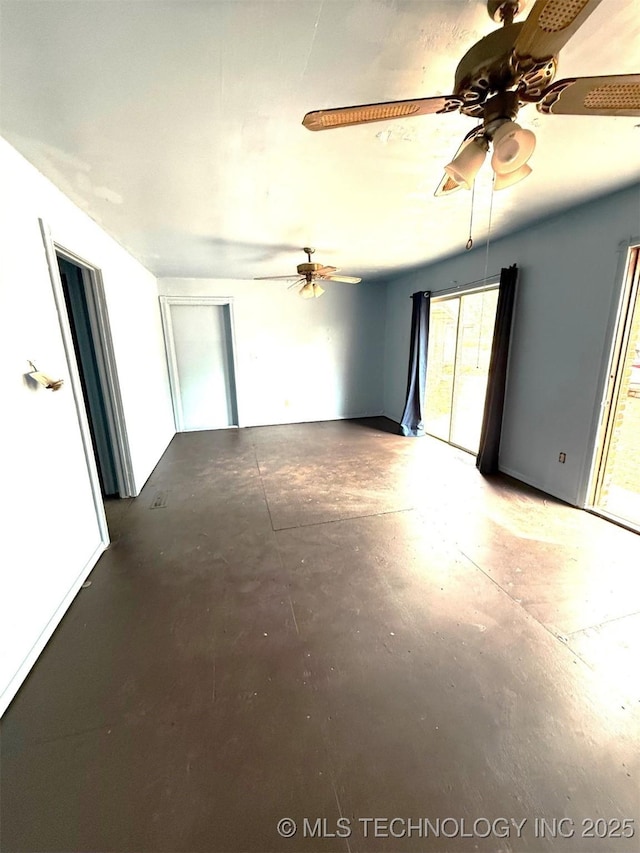 interior space with concrete flooring and ceiling fan