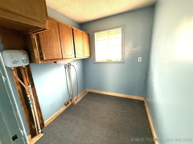 laundry room featuring laundry area, baseboards, carpet floors, and a textured ceiling