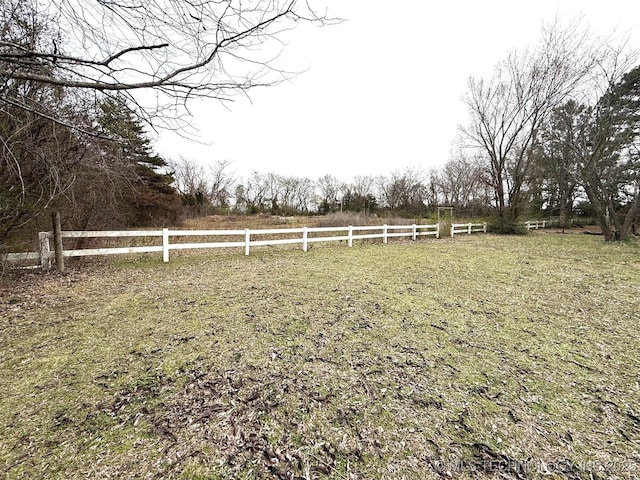 view of yard featuring a rural view and fence