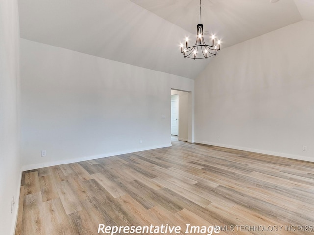 spare room featuring a notable chandelier, baseboards, light wood-style floors, and high vaulted ceiling