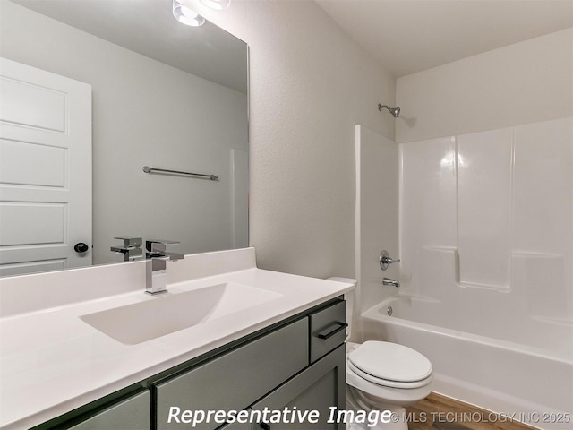 bathroom featuring vanity, wood finished floors, toilet, and tub / shower combination