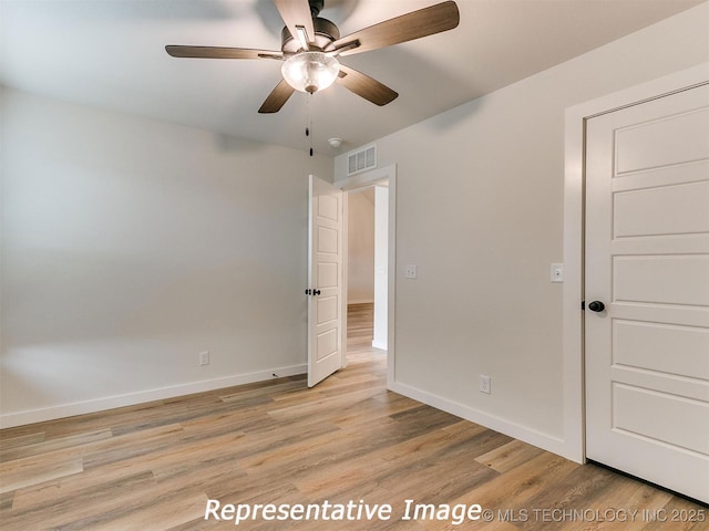 unfurnished bedroom with baseboards, visible vents, light wood finished floors, and ceiling fan