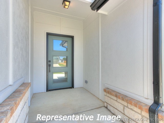 property entrance with stucco siding