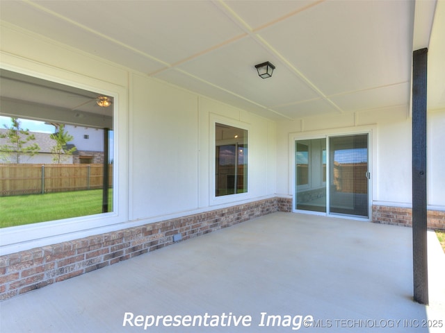 view of patio featuring fence