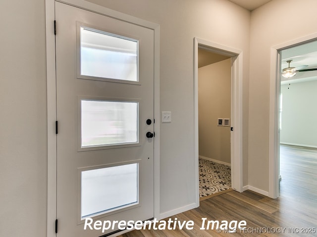 foyer featuring wood finished floors and baseboards