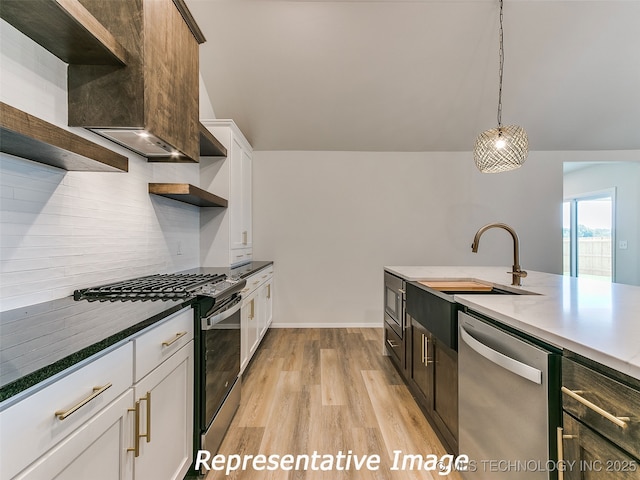 kitchen featuring light wood-type flooring, open shelves, tasteful backsplash, white cabinetry, and appliances with stainless steel finishes