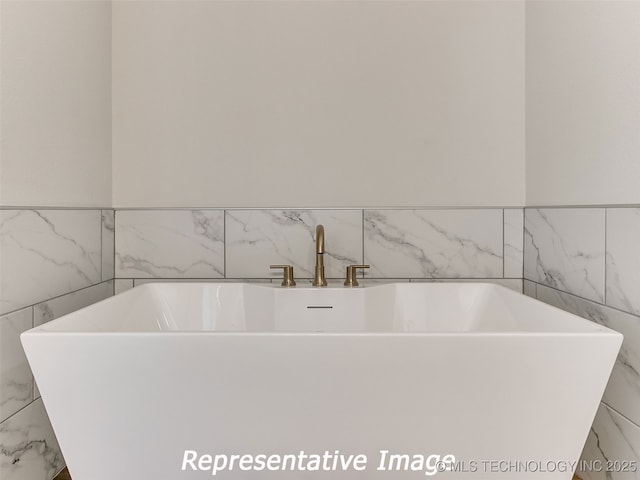 bathroom featuring a freestanding bath and a sink