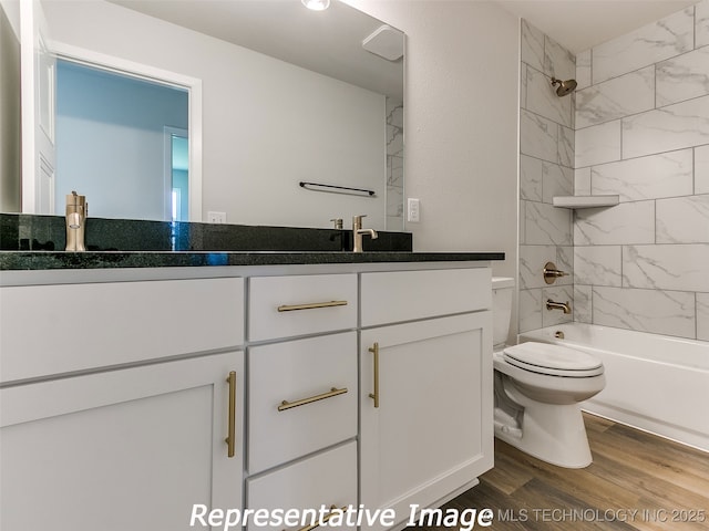 bathroom featuring shower / bath combination, toilet, vanity, and wood finished floors