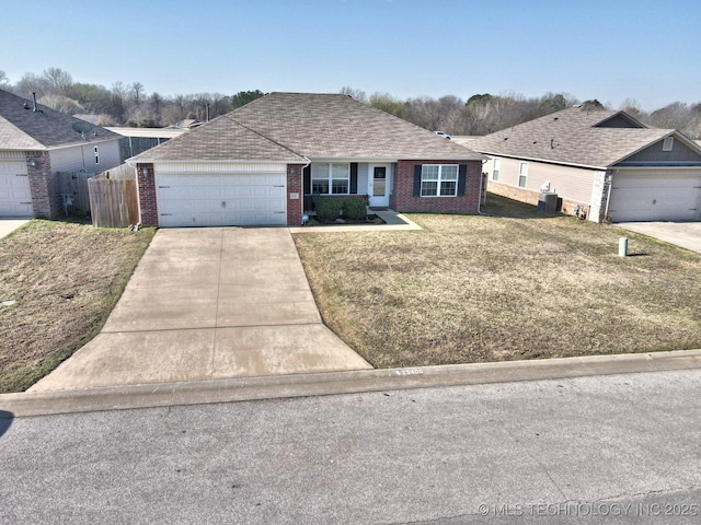 single story home featuring fence, concrete driveway, an attached garage, a front yard, and brick siding