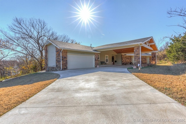 view of front of property featuring stone siding, driveway, and a front lawn