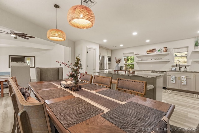 dining room featuring recessed lighting, visible vents, a healthy amount of sunlight, and light wood finished floors