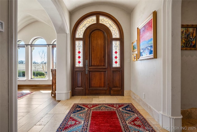 3217 E 61st Pl, Tulsa, OK 74136 - entrance foyer featuring baseboards, arched walkways, and vaulted ceiling