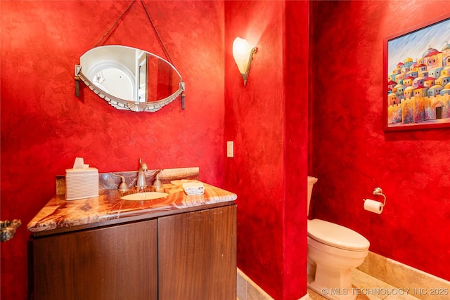 3217 E 61st Pl, Tulsa, OK 74136 - half bath featuring toilet, tile patterned flooring, vanity, and baseboards