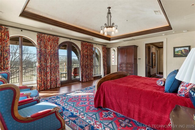 3217 E 61st Pl, Tulsa, OK 74136 - bedroom featuring crown molding, access to exterior, visible vents, and a raised ceiling