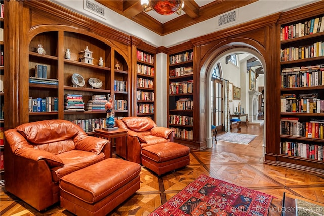 3217 E 61st Pl, Tulsa, OK 74136 - sitting room featuring visible vents, coffered ceiling, arched walkways, bookshelves, and built in shelves
