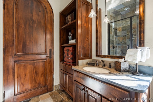 3217 E 61st Pl, Tulsa, OK 74136 - full bath featuring stone finish flooring, a stall shower, built in features, and vanity