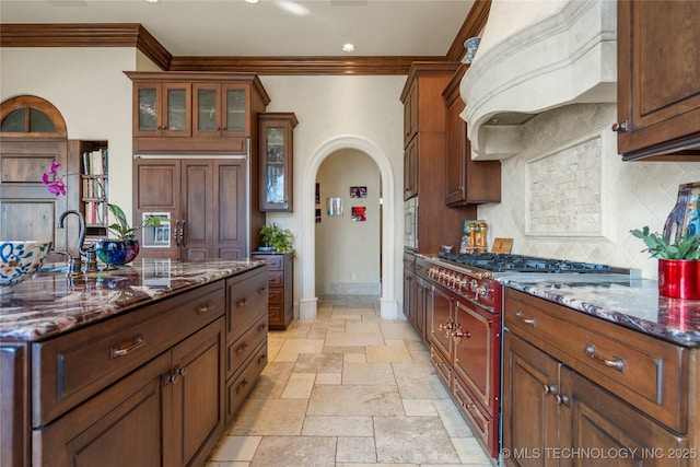 3217 E 61st Pl, Tulsa, OK 74136 - kitchen featuring tasteful backsplash, custom exhaust hood, stone tile flooring, high end range, and crown molding