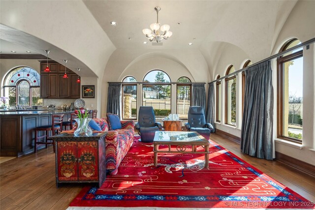 3217 E 61st Pl, Tulsa, OK 74136 - living room featuring a chandelier, hardwood / wood-style flooring, and plenty of natural light