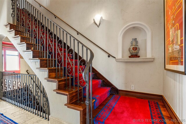 3217 E 61st Pl, Tulsa, OK 74136 - staircase featuring baseboards and wood finished floors